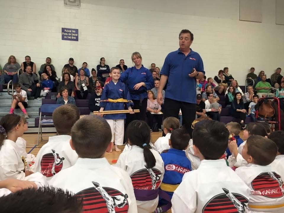 Grand Master Stephen Oliver congratulating a student at a Mile High Karate belt graduation