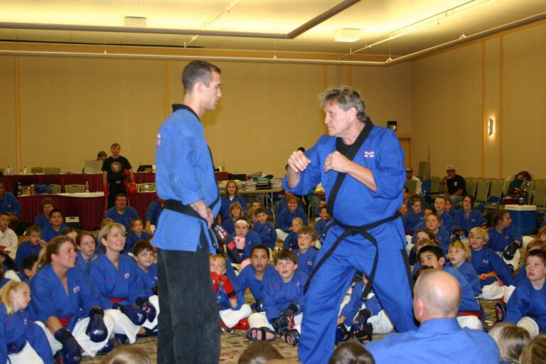 Black Belt in fighting stance demonstrating for a room of seated students at the 2007 Champion's Reunion