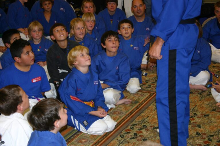 Young Mile High Karate students seated on the floor watching an instructor at the 2007 Champion's Reunion
