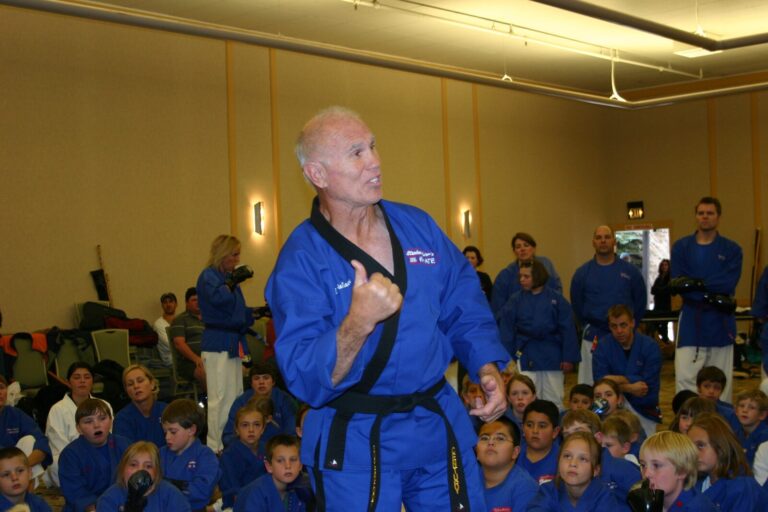 Bill Wallace, his name embroidered on his blue uniform, speaking to students at the 2007 Champion's Reunion
