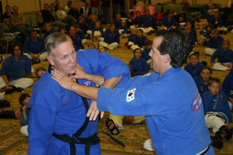 Jeff Smith, wearing a uniform embroidered Master Smith, demonstrating a defense against a choke at the 2007 Champion's Reunion