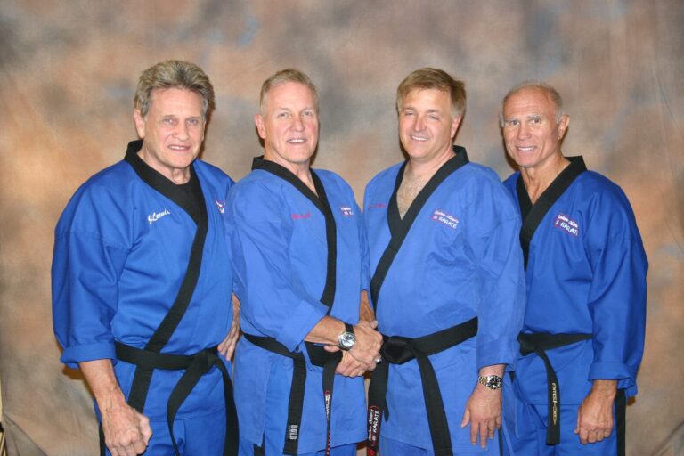 Four Black Belts in blue Stephen Oliver's Mile High Karate uniforms posing for a group portrait at the 2007 Champion's Reunion